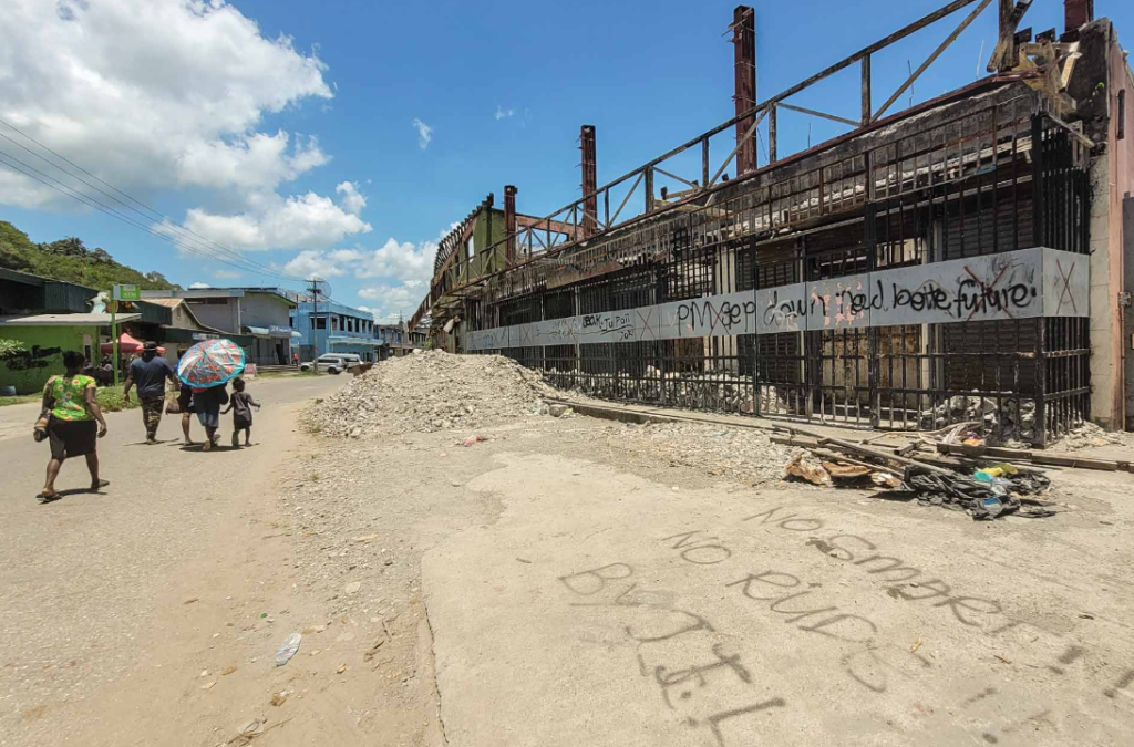 Graffiti on a building being reconstructed following the 2021 Honiara riots.[[Photo credit: Dan McGarry]]