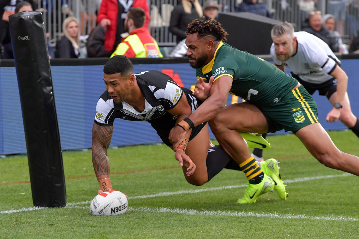 Jamayne Isaako of the Kiwis scores a try in the tackle of Hamiso Tabuai-Fidow of Australia during the Men's Pacific Championships match between New Zealand Kiwis and Australian Kangaroos at Apollo Projects Stadium in Christchurch, Sunday, October 27, 2024. (AAP Image/John Davidson, via Photosport)