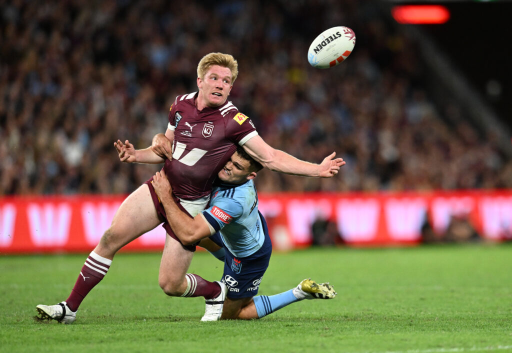 Tom Dearden (left) of the Maroons is tackled by Nathan Cleary of the Blues during the State of Origin game one match between the Queensland Maroons and the New South Wales Blues at Suncorp Stadium in Brisbane, Wednesday, May 28, 2025.