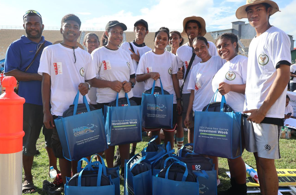 Kids who took part in the walk against corruption wearing white tshirts and holding blue goodie bags they won for being the best dressed group.