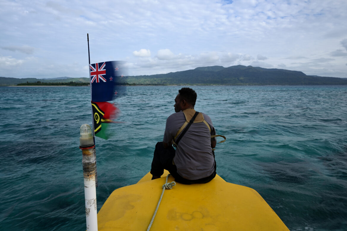 Young Melanesian man sitting on a floater looking out at sea.