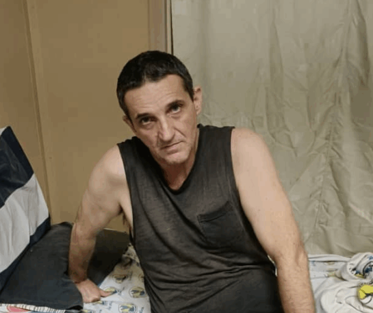 Caucasian man wearing a black singlet