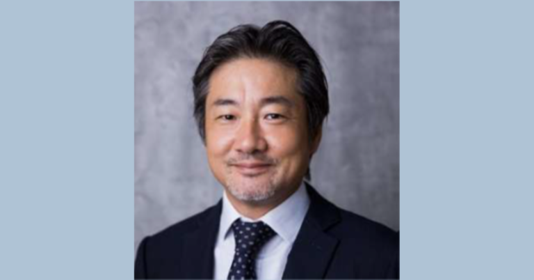 Portrait of an Asian man with dark her wearing a black suit and tie