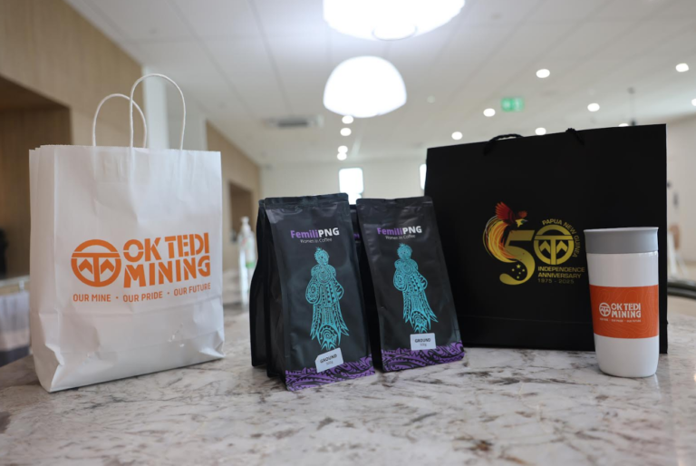 Ok Tedi and Femili PNG Partner to Tackle Domestic Violence Ok Tedi labelled paper bag and Two black cover wrapped packages of coffee