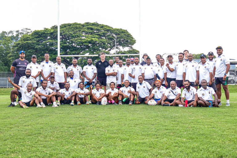 Group photo of accredited match official with trainer.