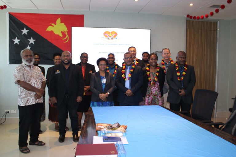 Vanuatu Delegation Studies PNG Public Service Housing Plans Men and women in suits posing for a photo