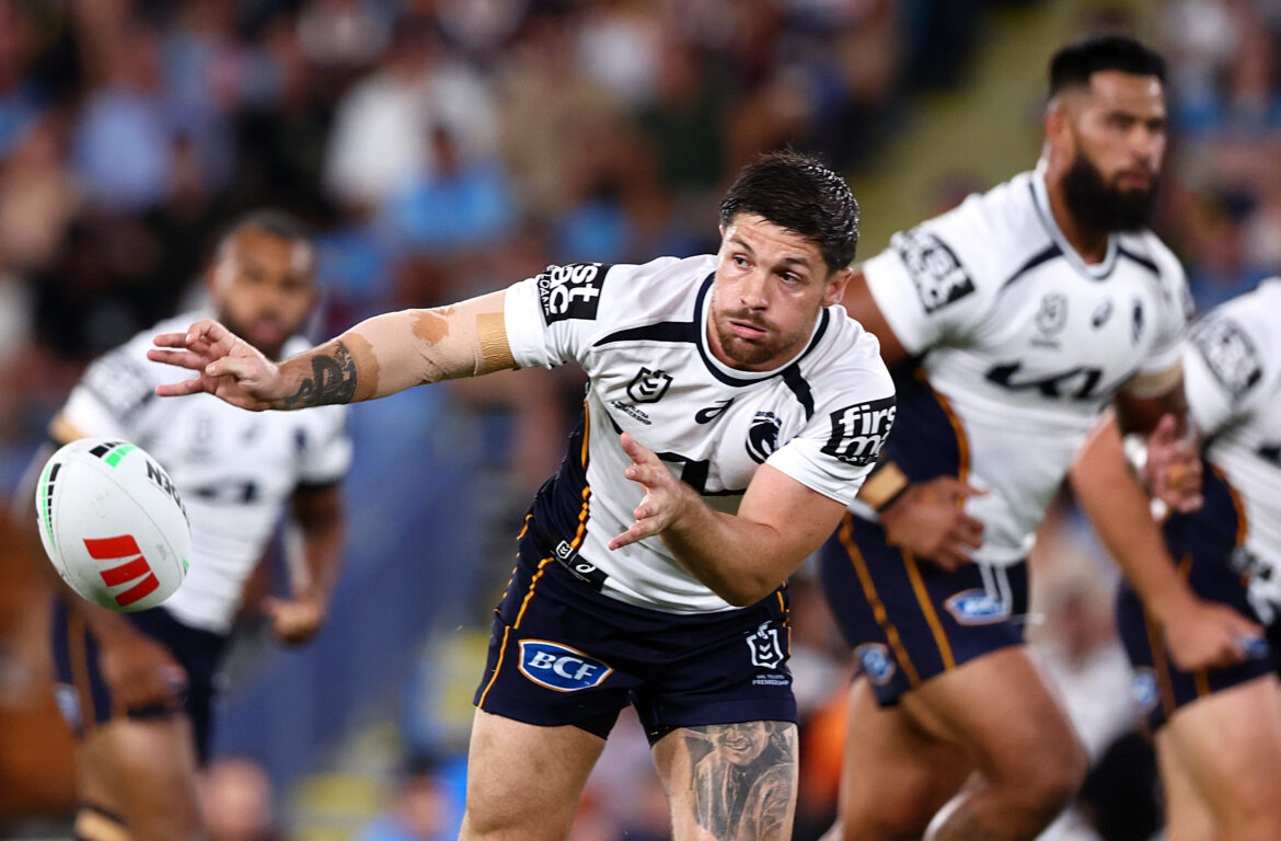 White male rugby player in motion looking disoriented on the field of play.
